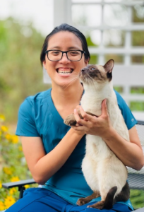 Sophia Chao smiling and holding a cat