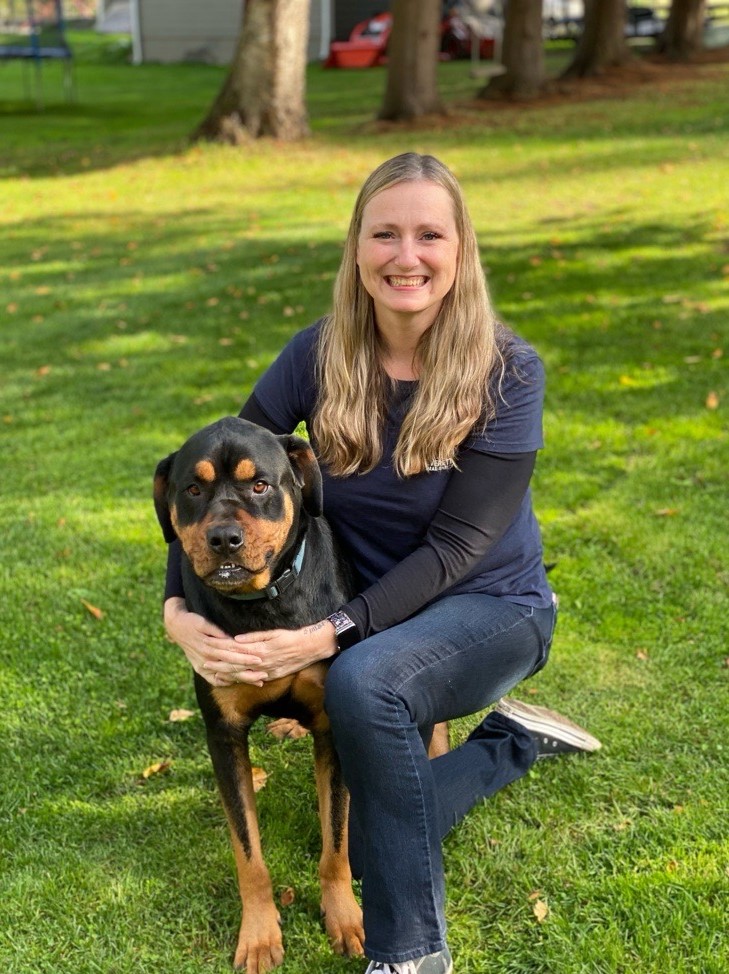 smiling woman holding dog