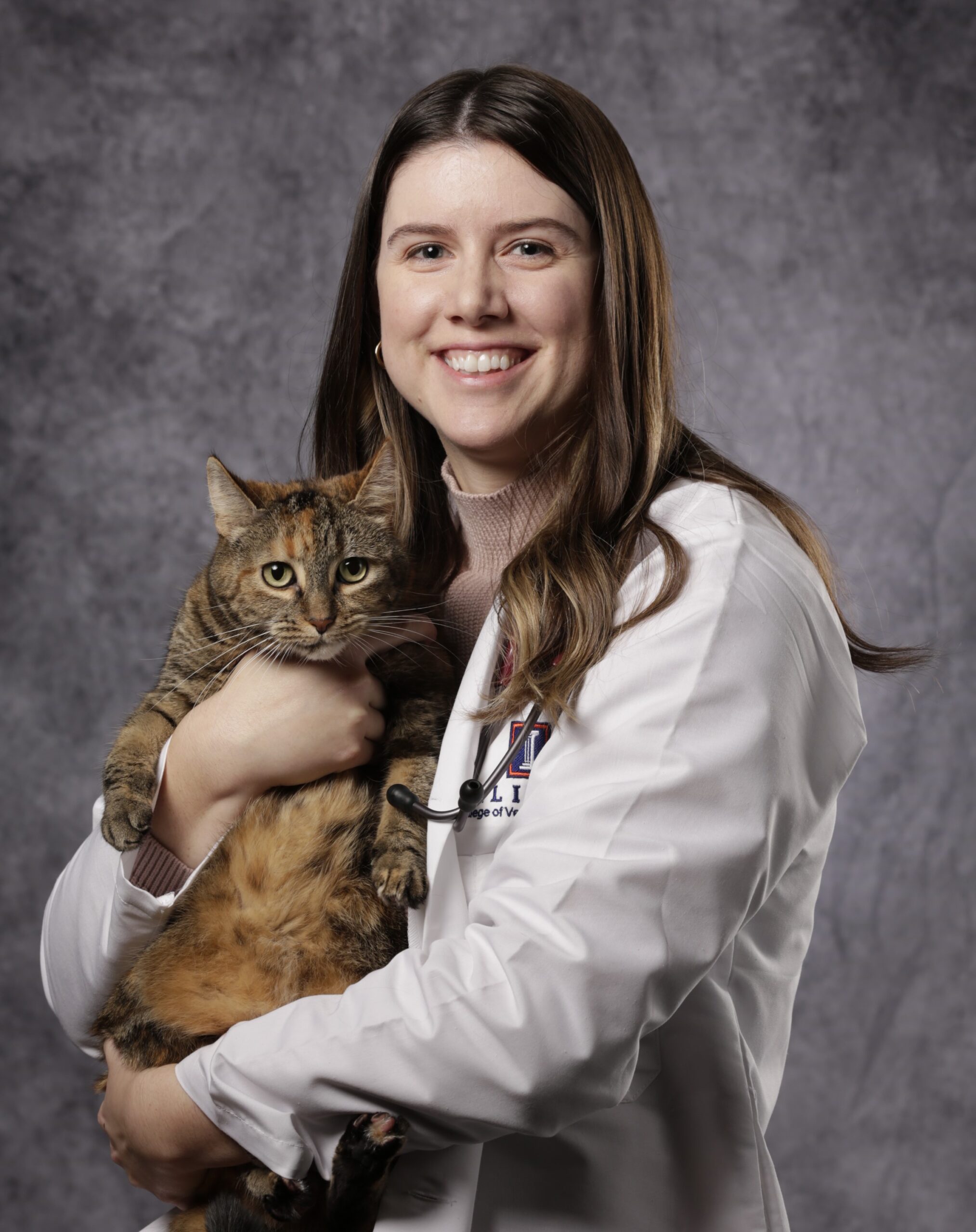 Dr Boyer smiling and holding a cat