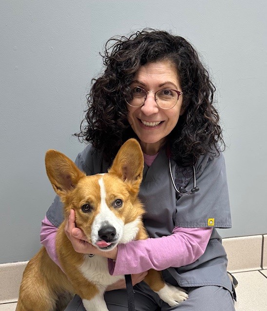 Dr Padilla-Kruk smiling and holding dog
