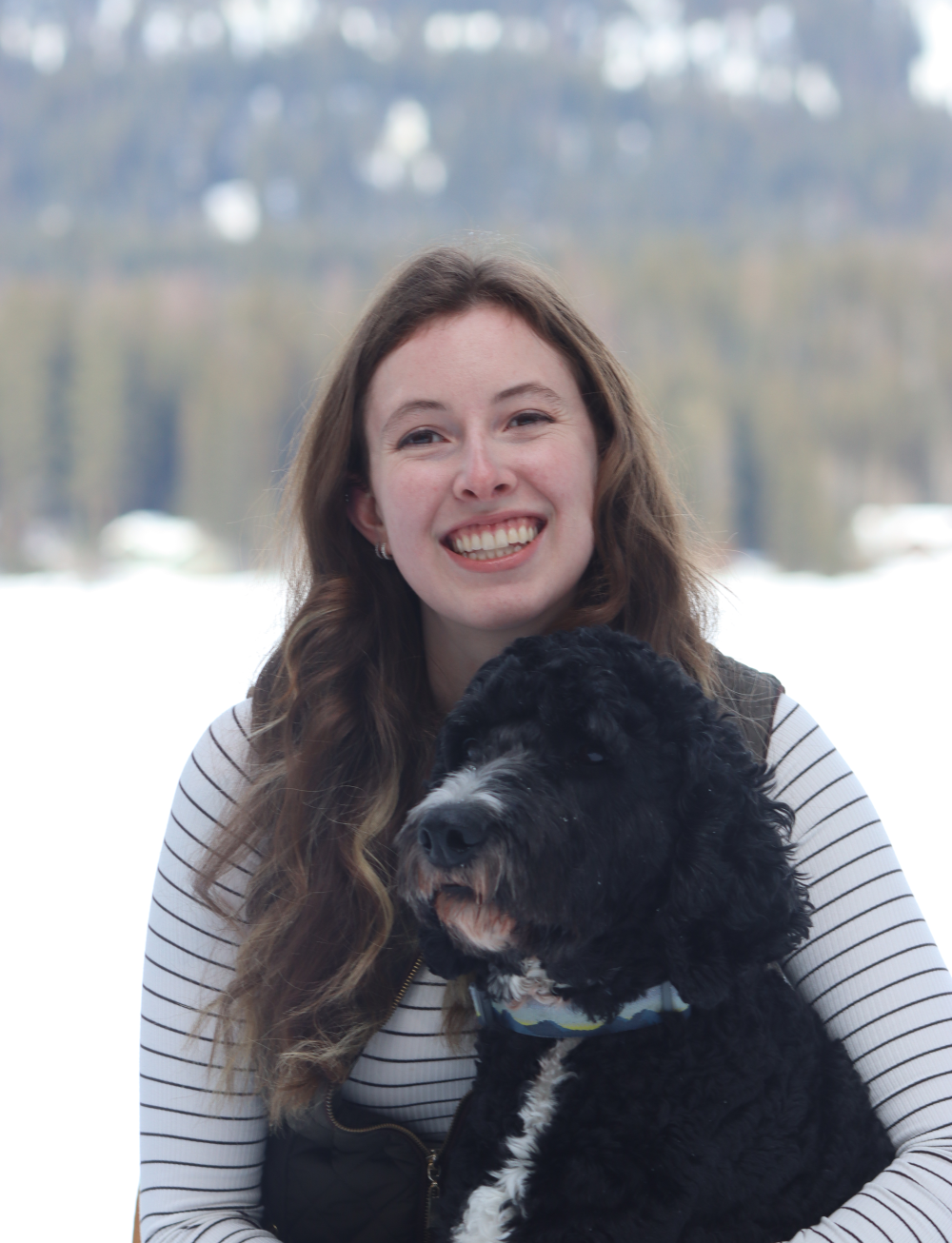Dr. Atchley smiling and holding a dog