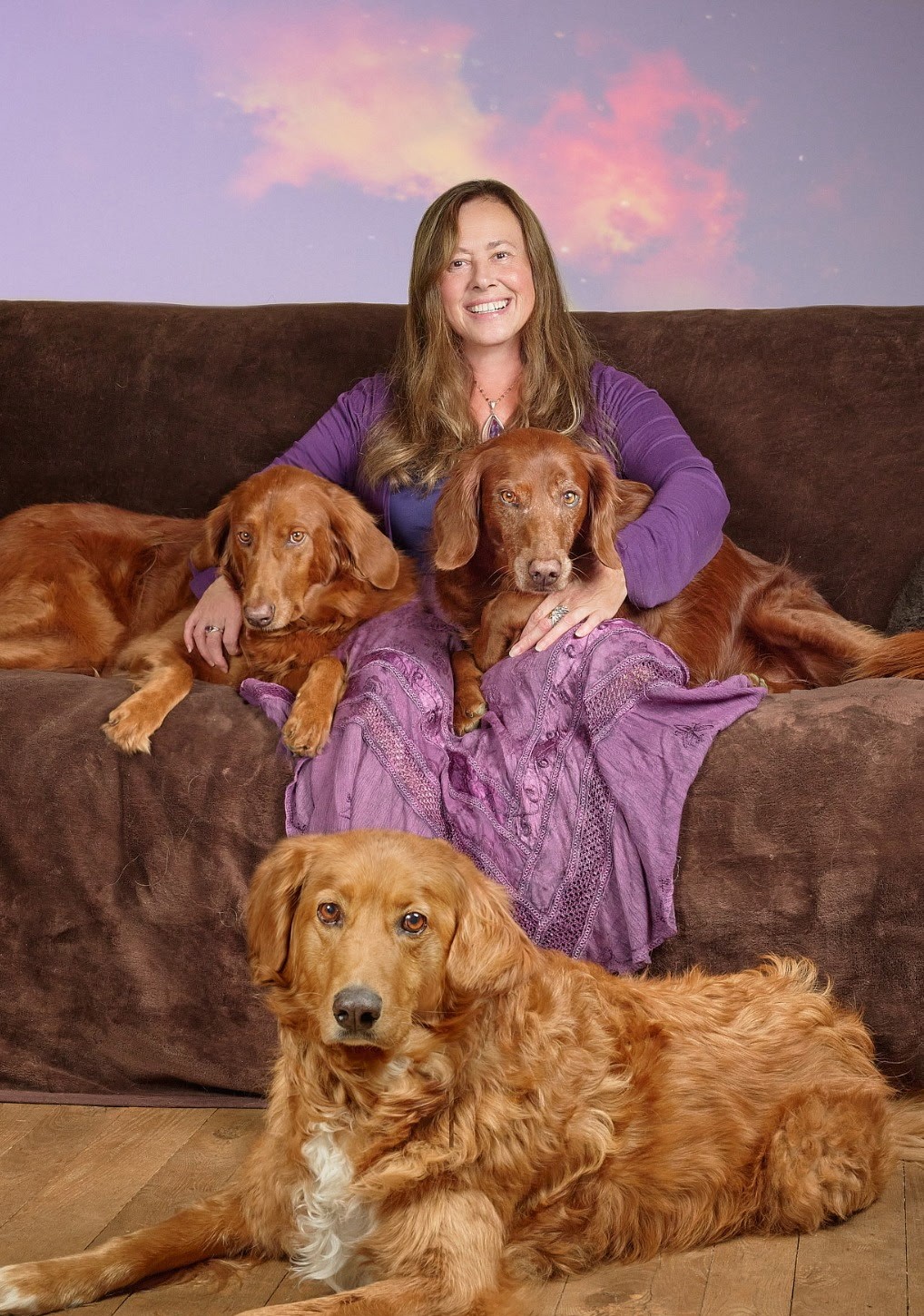 Marina Lovell smiling with 3 dogs