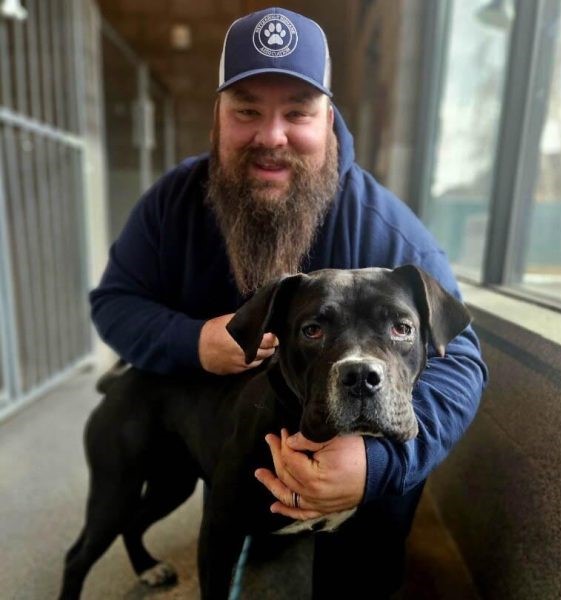 Tucker Chase holding dog and smiling